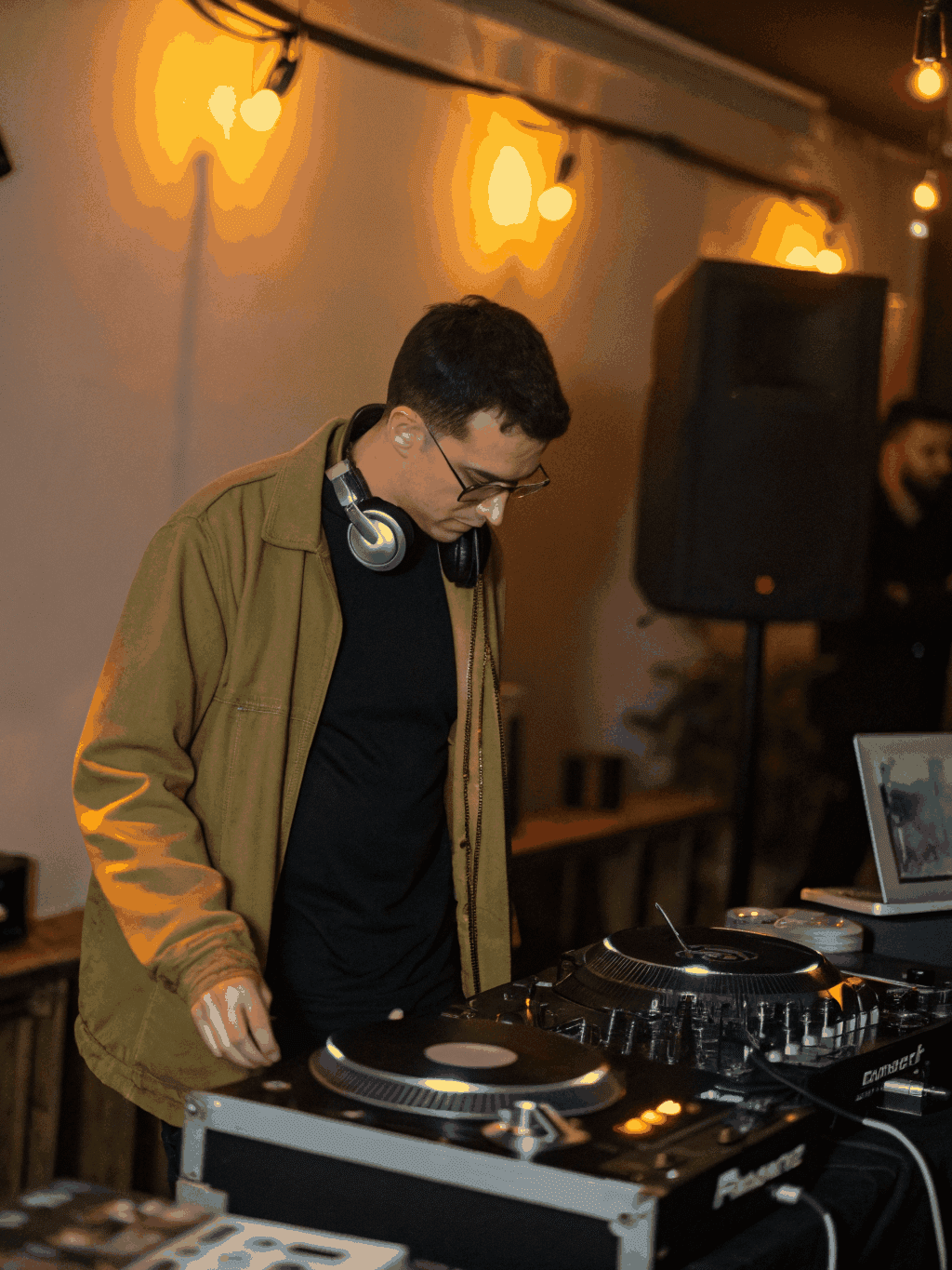 DJ spinning classic reggae vinyl in a neon-lit studio